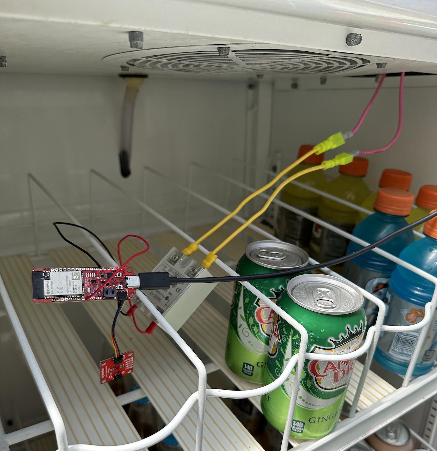 The inside of the fridge, showing the microcontroller and peripherals with wires connecting them.